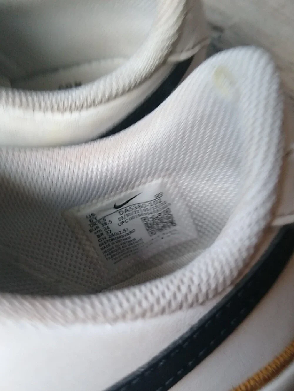 Nike White Low-Top Sneakers with Black Swoosh and Brown Stripe